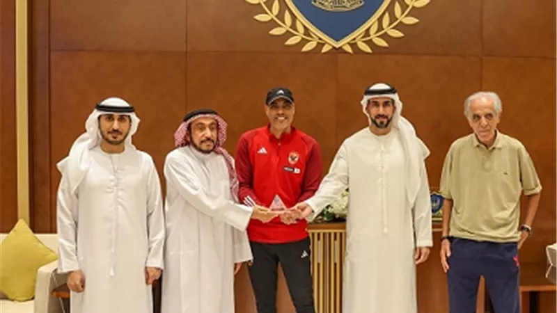 خالد بيبو يُهدى نادى الشرطة بعجمان درع وعلم الأهلي